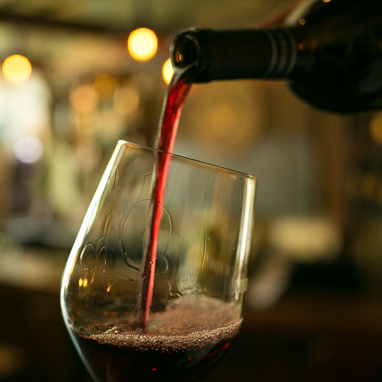Red Wine being poured in a wine glass