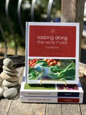 Tasting Along the Wine Road Cookbook foreword by Jesse Mallgren volume 10 attractively displayed on a barrel