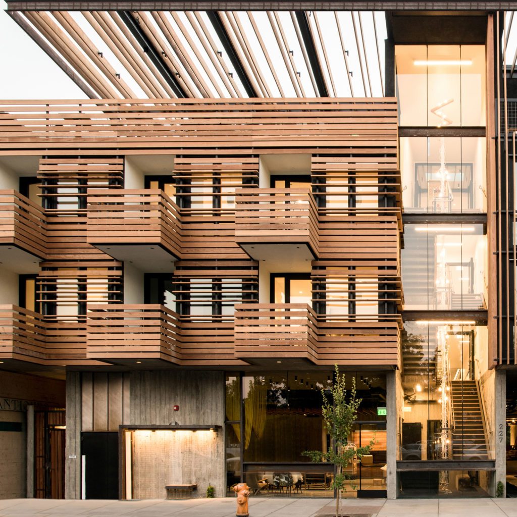 Brown wood slatted walls and balconies showcase the exterior of the Harmon Guest House.