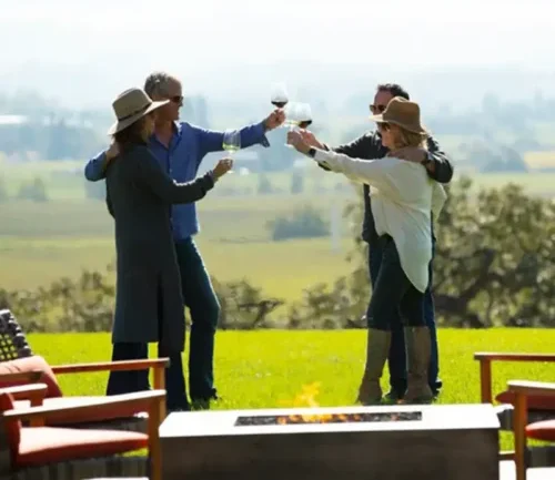 Two couples raising their wine glasses to toast
